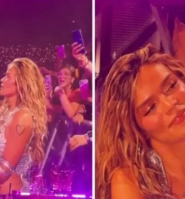 Karol G en tarima con una niña. Foto: Capturas de video. El Colombiano.