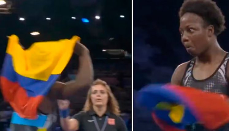 Con la bandera bien puesta sobre su espalada, la luchadora de Valle del Cauca se disponía dar la vuelta olímpica, pero una jueza se le acercó y la paró.