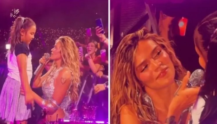 Karol G en tarima con una niña. Foto: Capturas de video. El Colombiano.